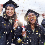 Two recent graduates excited about graduation and receiving their diplomas