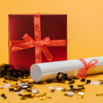 A diploma with a red bow and gold glitter