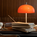 An office desk, lamp, file folders, and paperwork